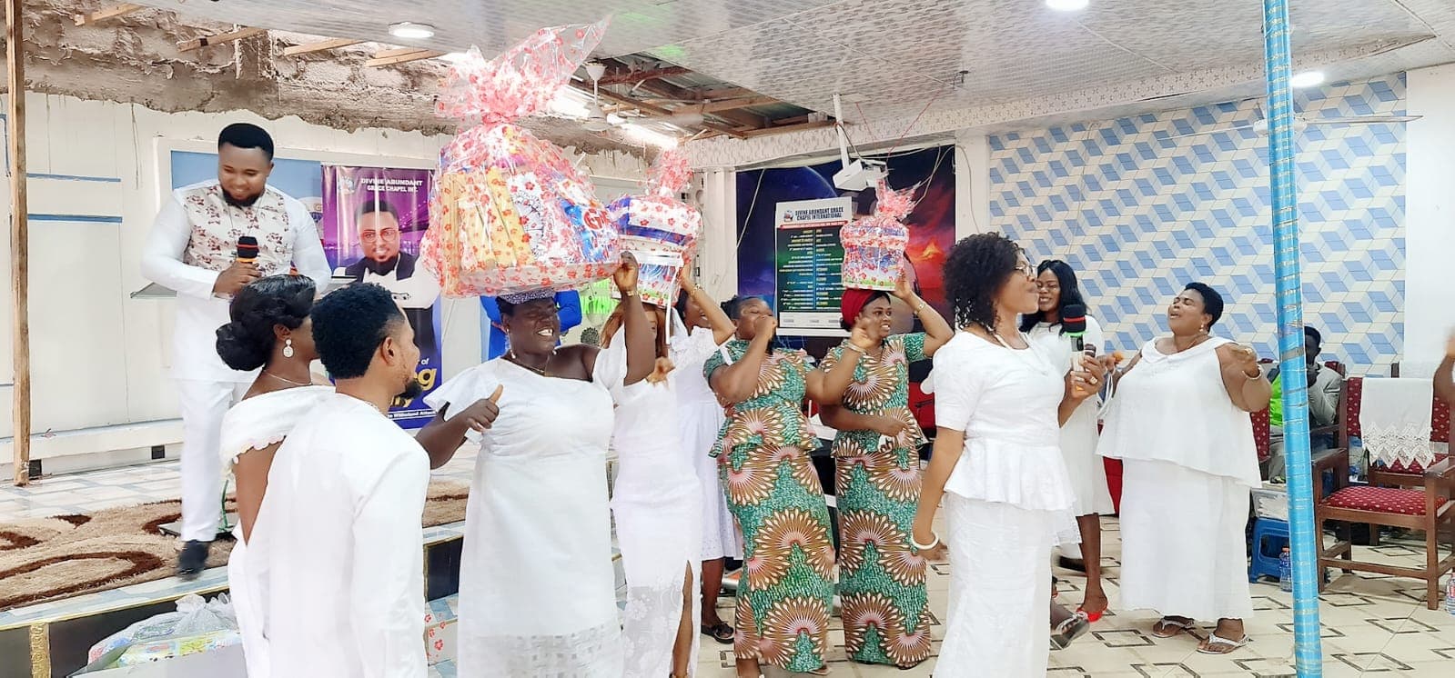 A celebration day at DAG Foundation — women bringing baskets of gifts into the chapel.