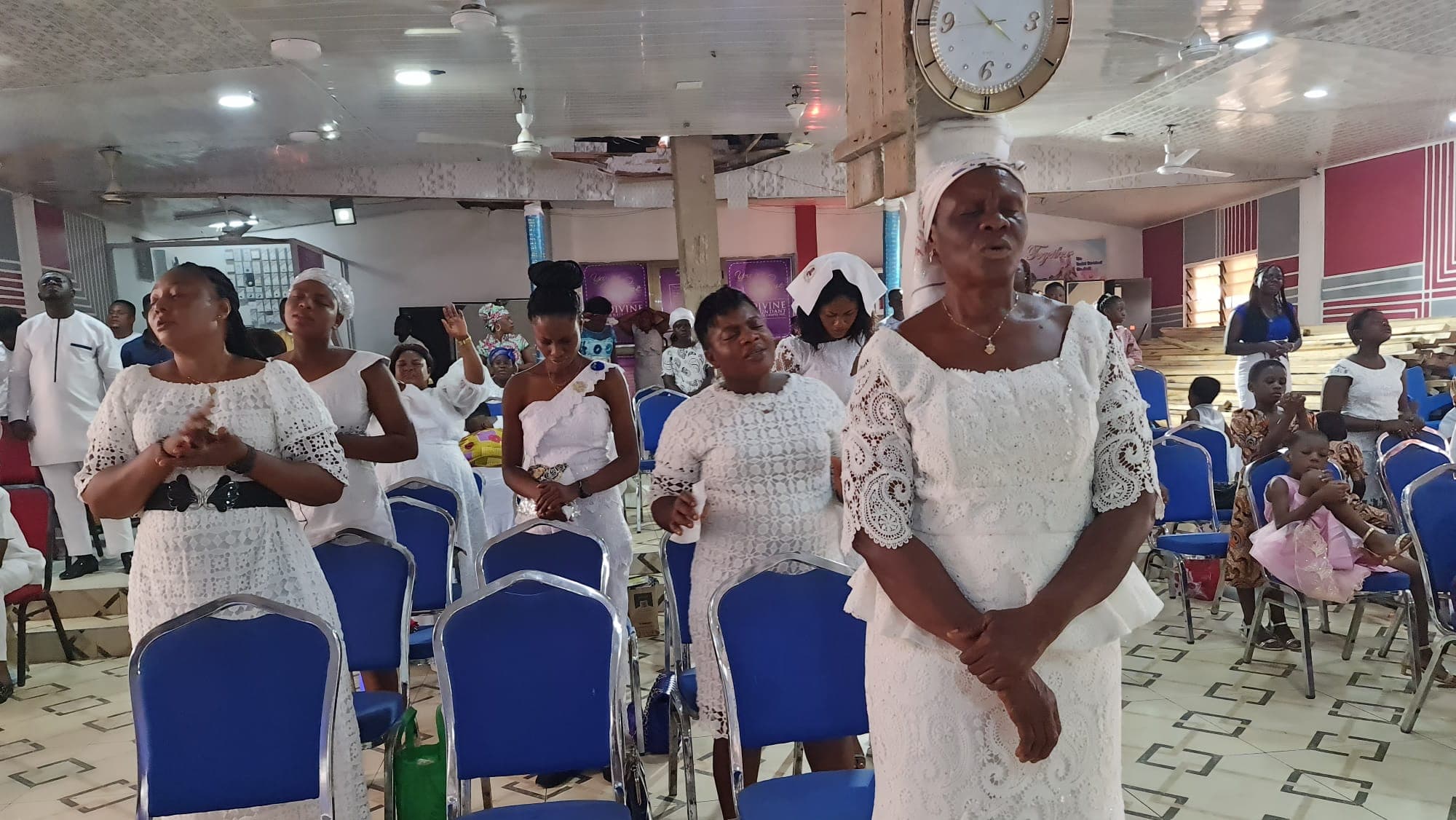 The congregation of DAG Foundation standing for worship.